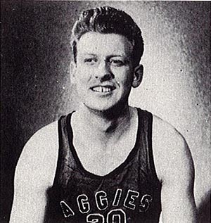 A black and white head shot of Clay in his basketball uniform in 1948.