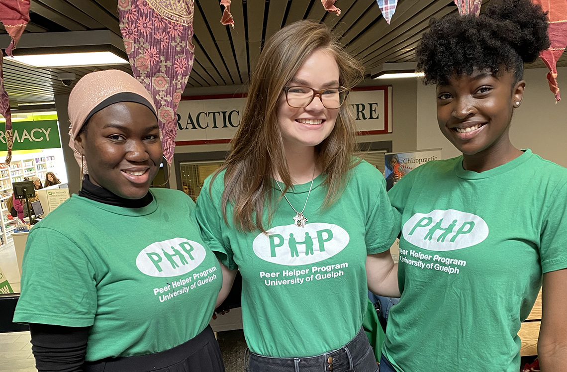 Three students in peer helper shirts.