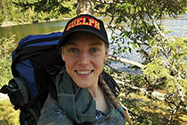 A selfie of Emilia, with a river behind her.