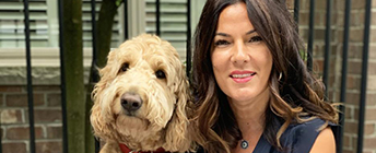 Leah sits with her dog Coco.