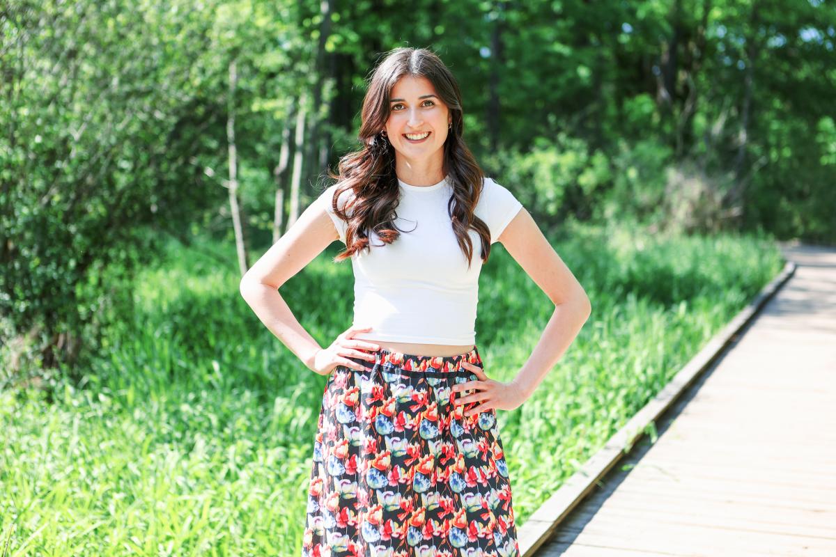 Marah smiling for the camera in the arboretum
