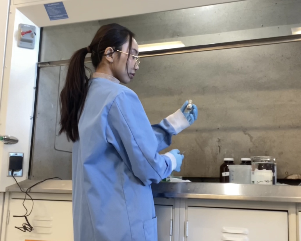 naifah in a lab, analyzing a specimen