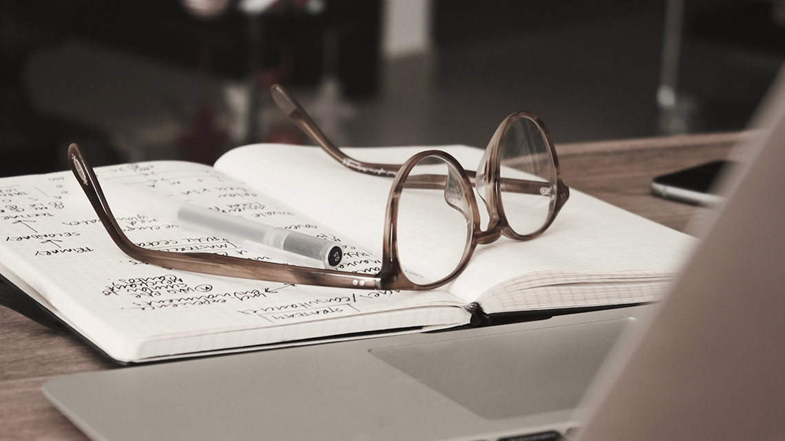 A pair of glasses on a book.