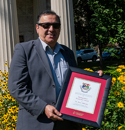 photo of nadar soltani, accepting peter's award on his behalf