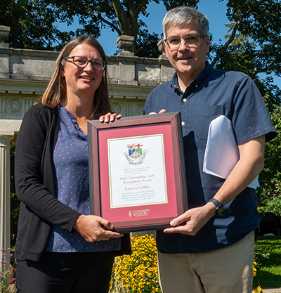 rebecca griffiths and john cranfield holding the staff award