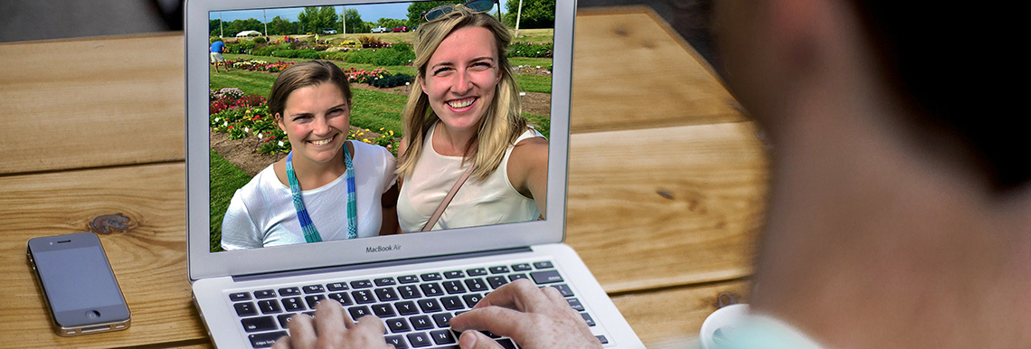 A person on a computer using virtual offerings.