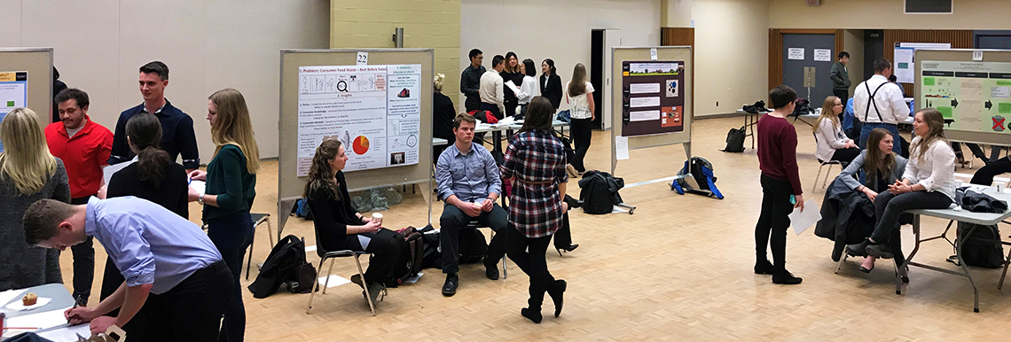 A landscape photo of students at their project showcase.