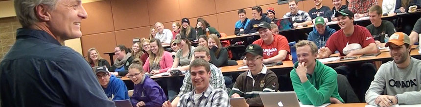 Prof. on far left addresses lecture room full of students