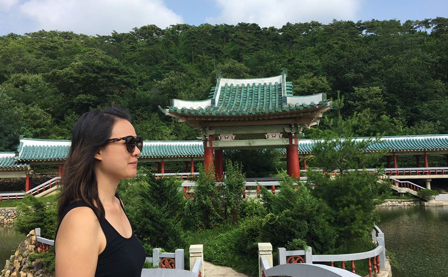 Carol poses in front of a temple.