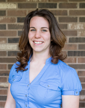 Abigail Carpenter standing in front of a brick wall