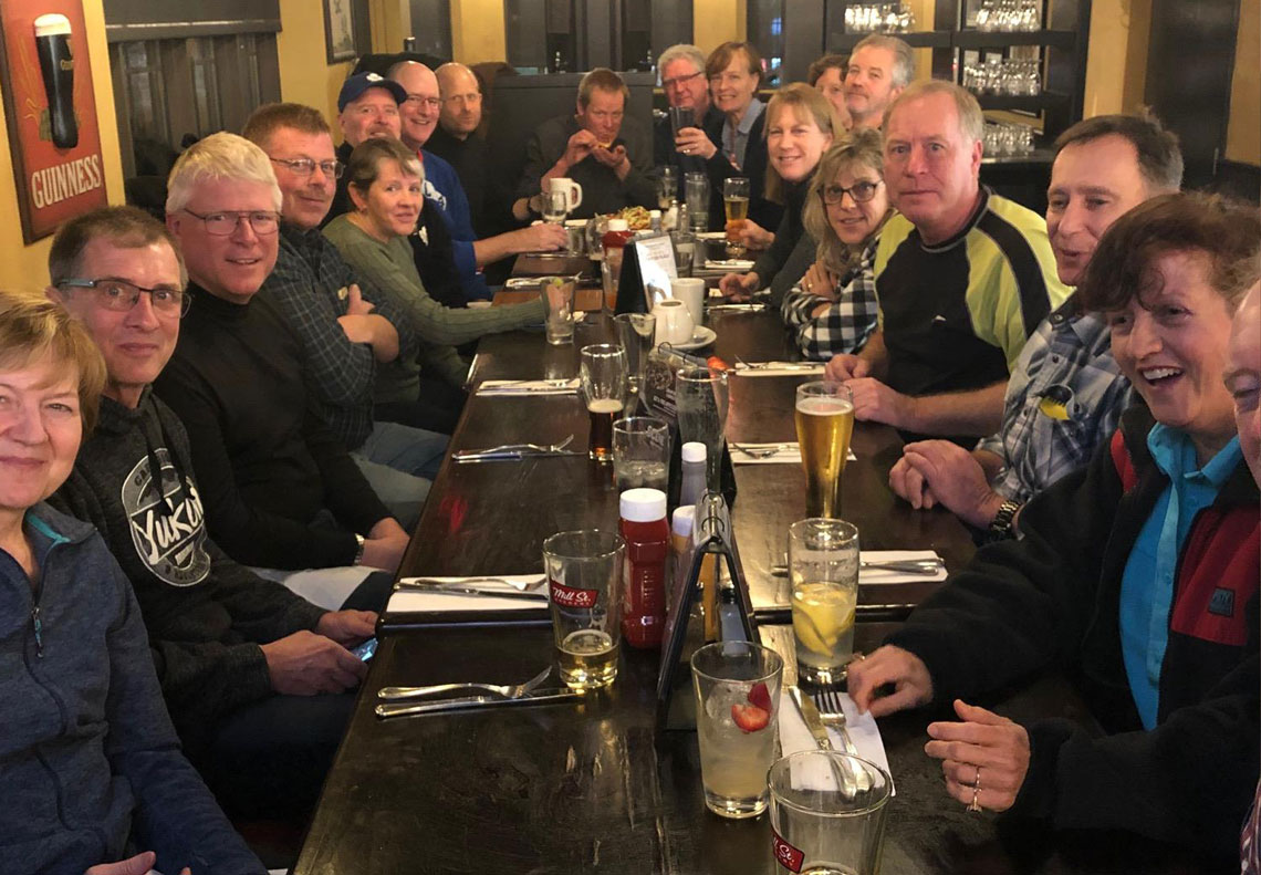 Group of alumni and spouses sitting at a table