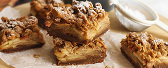 Apple Crumble Gingerbread Blondies sit on a table. 