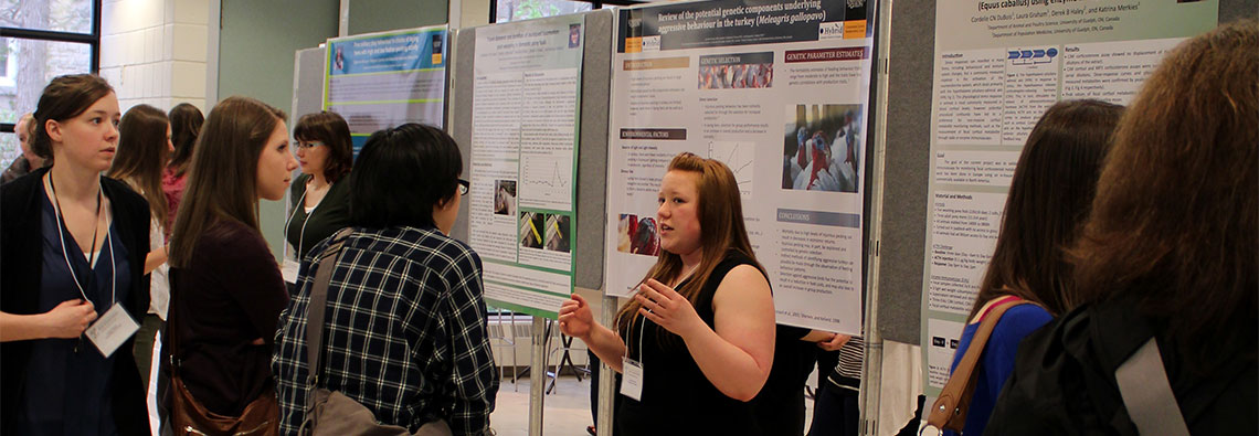 Graduate students discuss and explain their research posters