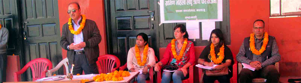 Ashley sitting at front of presentation to female farmers with other instructors