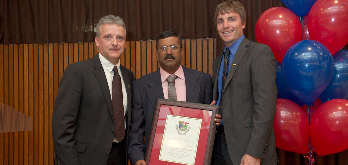 Rob Gordon and Clint Buttar present Jay Subramanian with framed award