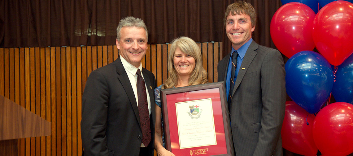 Rob Gordon and Clint Buttar present Claudia Wagner-Riddle with framed award