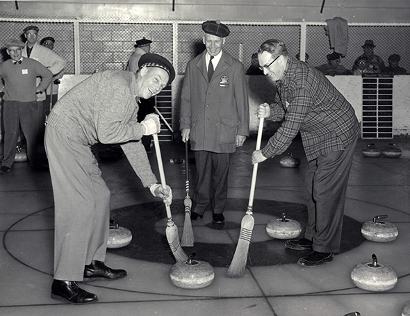 Black and white photo of Fred Presant, J.D. MacLachlan and Bob Pauley curling