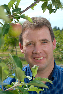 John Cline headshot in apple orchard