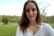 Head shot of Krista Kapitan standing on lawn.