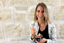 Kristi Storoschuk smiles while holding a small dessert cup.