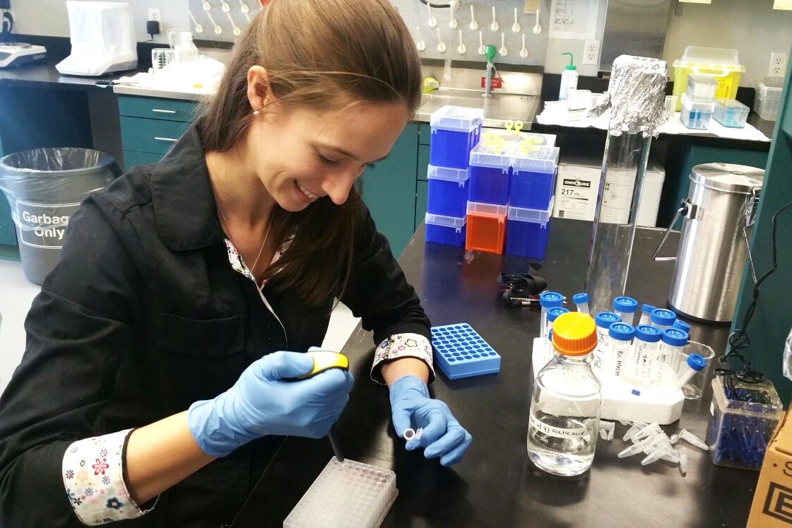 Lauren uses a pipette in a lab.