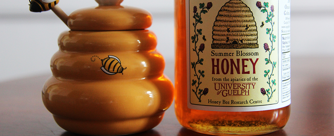 A honey pot and honey from U of G. 