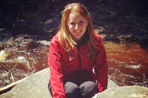 Marnie McKechnie sits by a river.