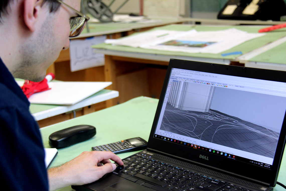 Michal works on a 3D model on his computer.