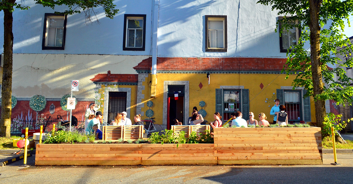 Wood seating structure on street in front of building