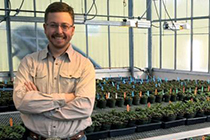 Chris stands in the greenhouse.
