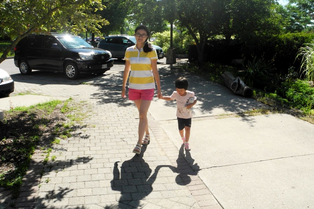 Qin walks with daughter.
