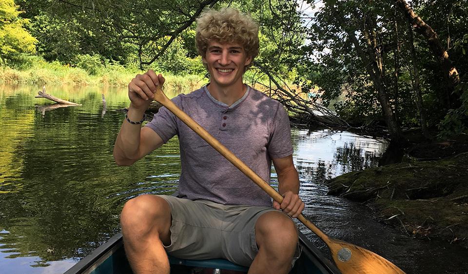 Owen sitting in a canoe.