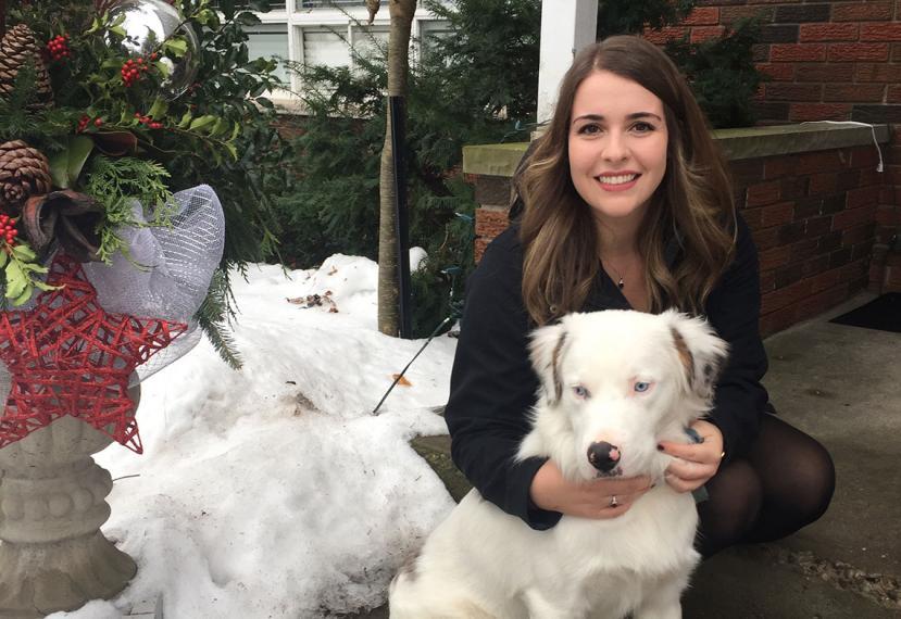 Emma huging white dog