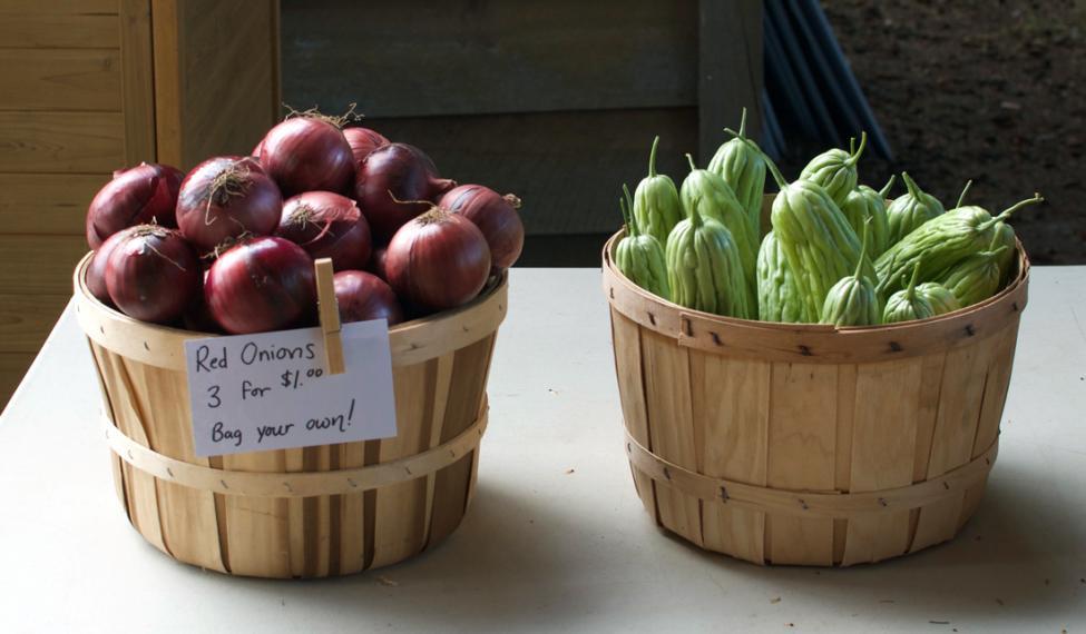 Red onions and green vegetables in baskets