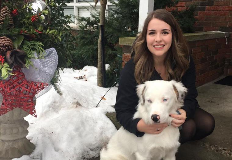 Emma huging white dog