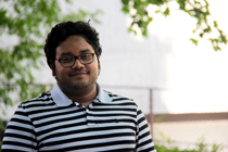 Syer Tazim Haque stands outside.