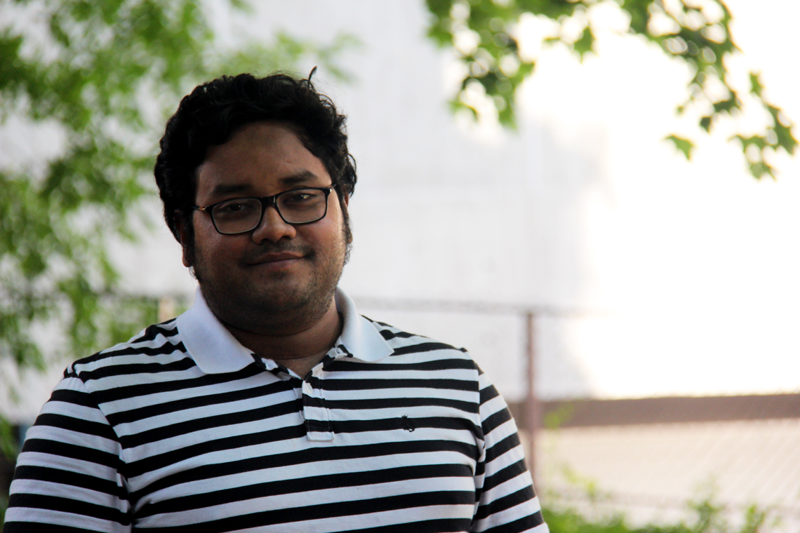 Syer Tazim Haque stands outside.