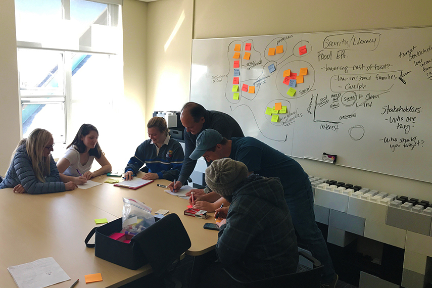 Vern works with a group of students on their project.