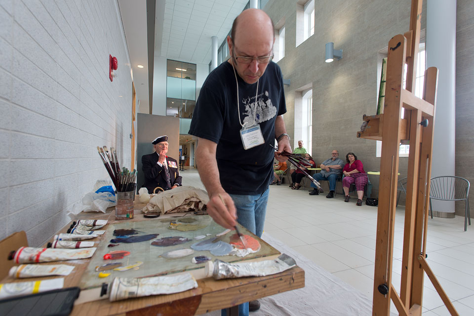 Guelph artist Greg Denton paints a portrait of former U of G president Bill Winegard for Remembrance Day project.