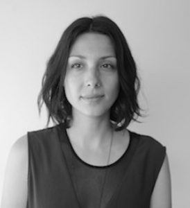 A black-and-white portrait of the artist.