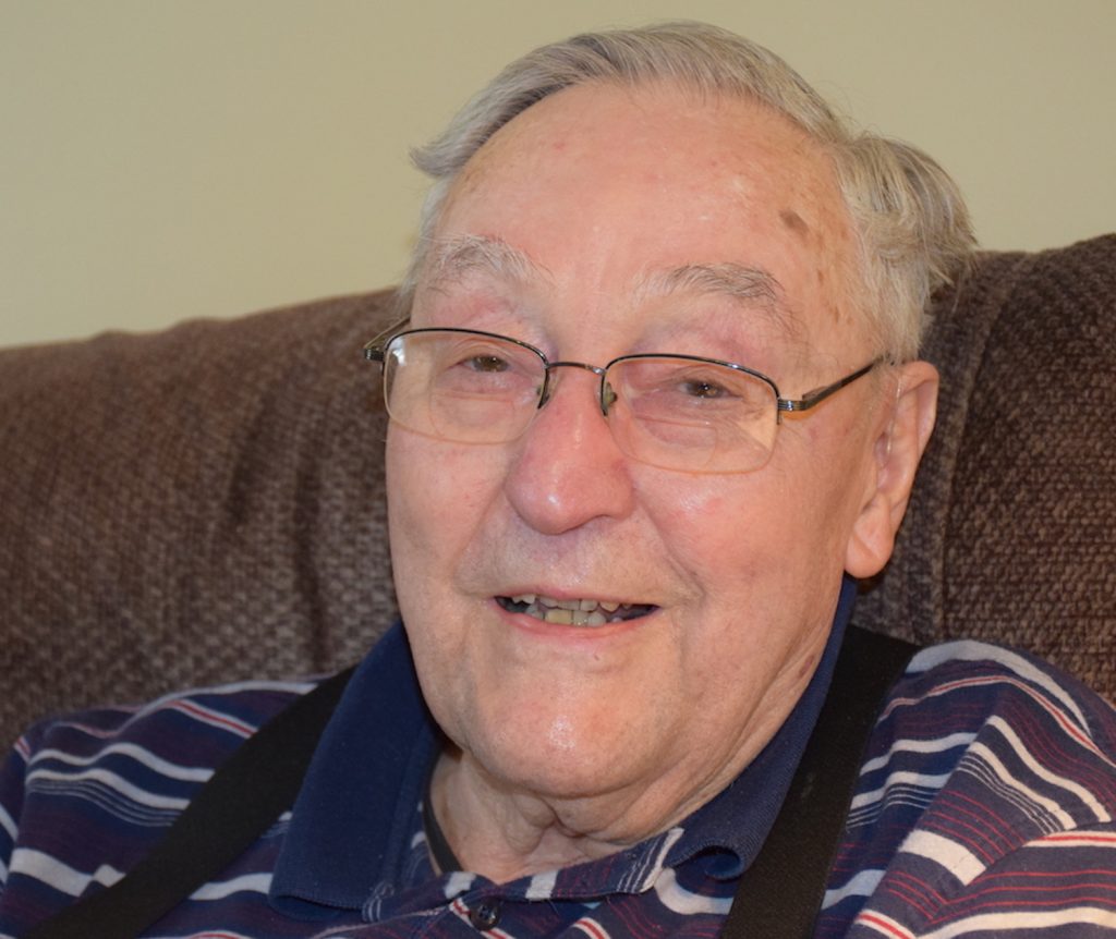 99-year-old retired professor, Henry Orr, smiling for the camera.