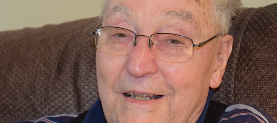 99-year-old retired professor, Henry Orr, smiling for the camera.