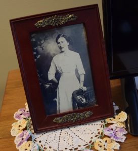An old photograph resting on handmade doily