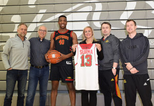 President Dr. Franco J. Vaccarino with Kinga Surma MPP and the mens basketball team