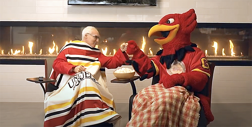 President Dr. Franco J. Vaccarino and University of Guelph mascot Gryph bumping fists