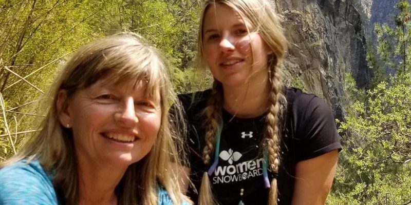 Mother and daughter in mountainous landscape