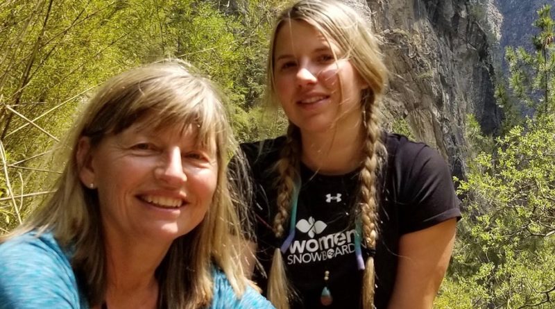 Mother and daughter in mountainous landscape