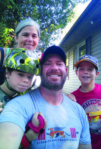 Scott McRoberts, director of athletics; his two children; Sonja Missio (back).