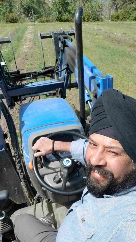 man looking back and smiling aboard tractor
