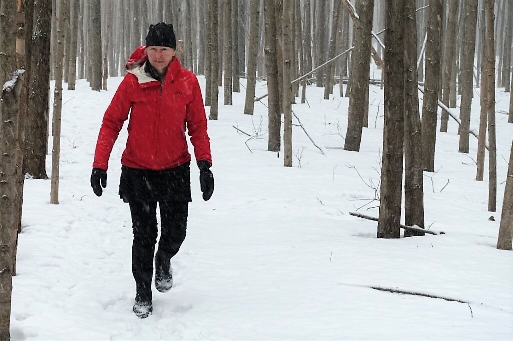 woman walking in snowy woods